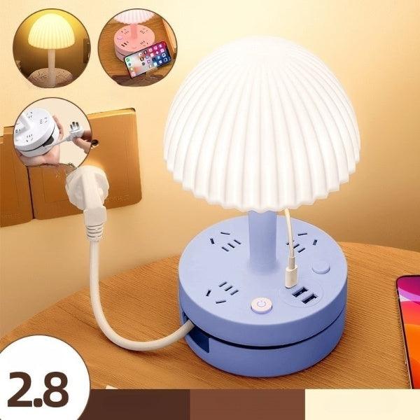 a table with a lamp and a cell phone on it