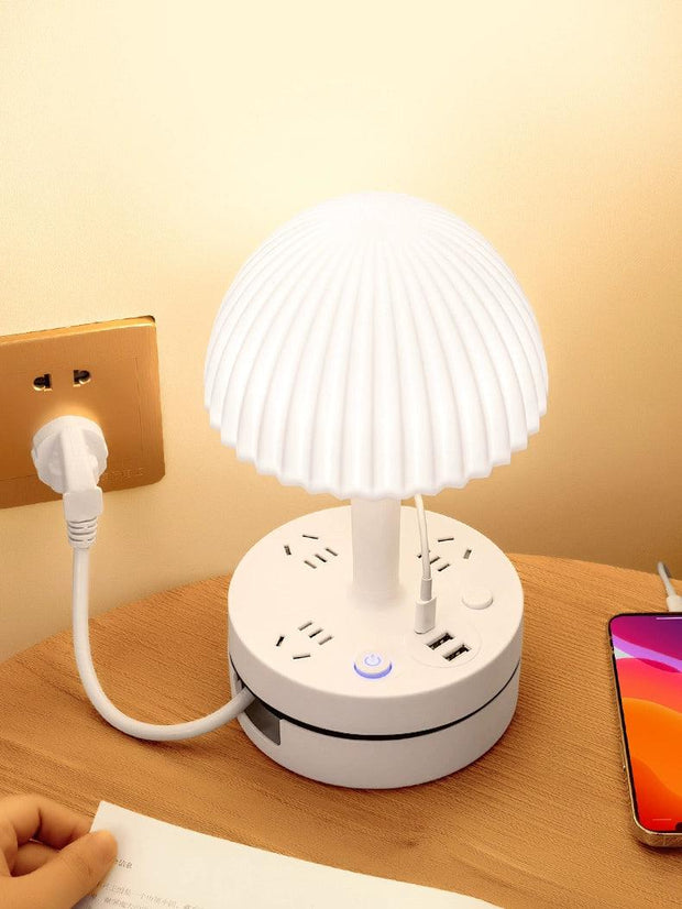 a white lamp sitting on top of a wooden table