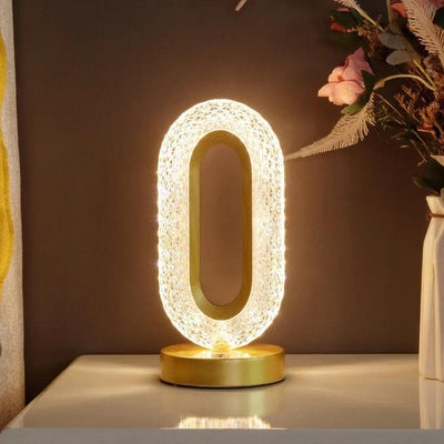 a clear glass crystal ring lamp night light sitting on top of a table