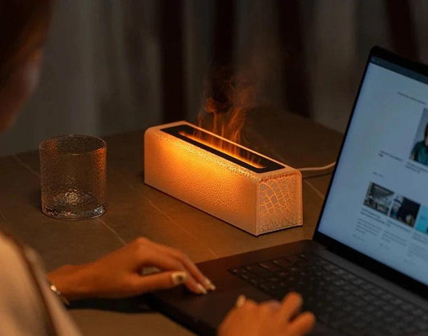 a woman sitting at a table using a fire humidifier