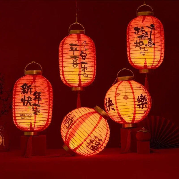 a group of red lanterns with asian writing on them