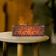 a wooden table topped with a burning speaker