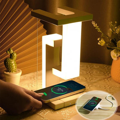 a nightstand with a glowing night light lamp and a phone charger on it