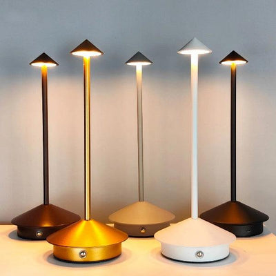 a group of three lamps sitting on top of a table