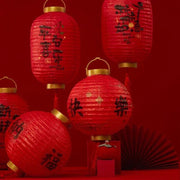 a group of red lanterns sitting on top of a table