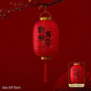 a red lantern hanging from a tree branch