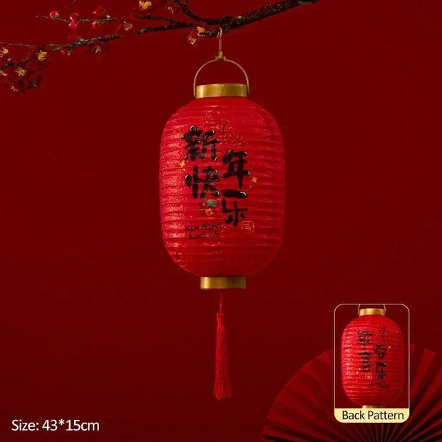 a red lantern hanging from a tree branch