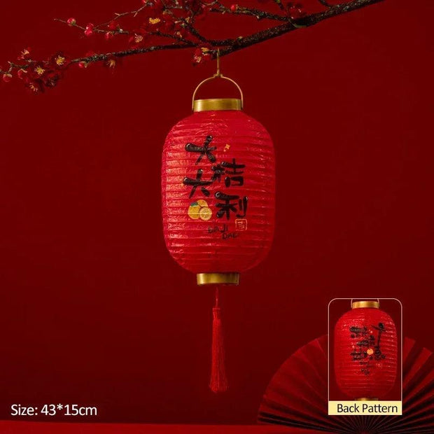 a red lantern hanging from a tree branch