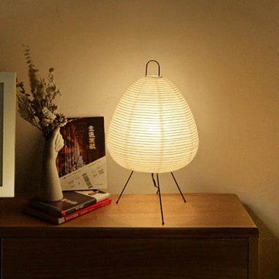 a white lamp sitting on top of a wooden table