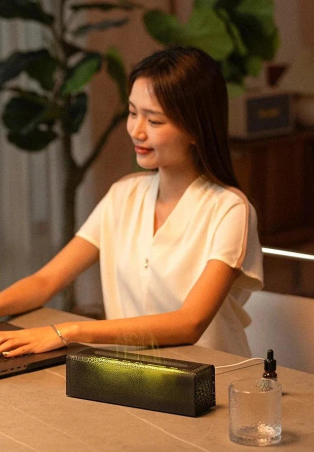 a woman sitting in front of a fire humidifier